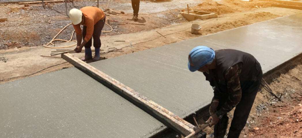 crew floating a newly poured concrete driveway