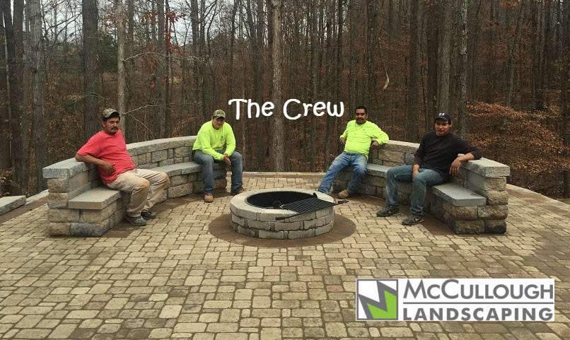 outdoor living area with fire pit and stone paver porch area