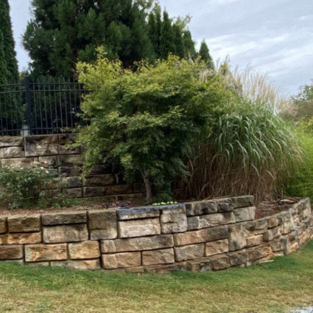 Wall of Redi-rock-gravity blocks used to support swimming pool